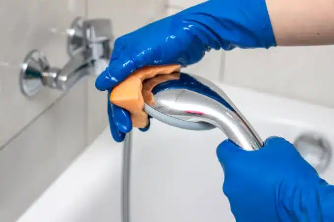 shower head being cleaned