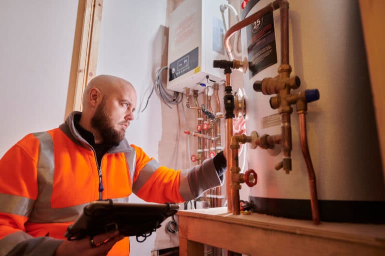 heating engineer servicing a residential boiler